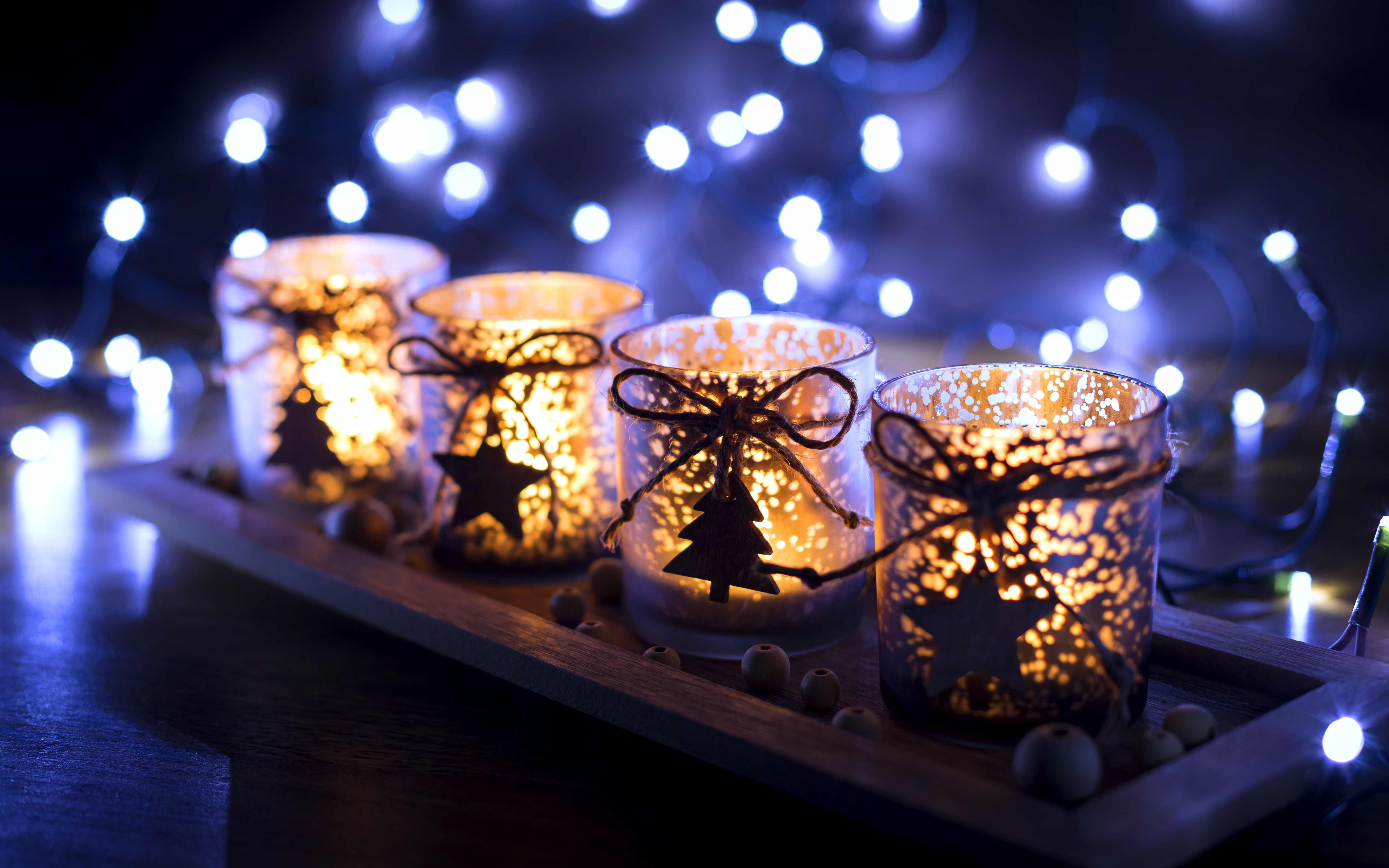 Advent, four candles decorated Christmas tree on a background of lights