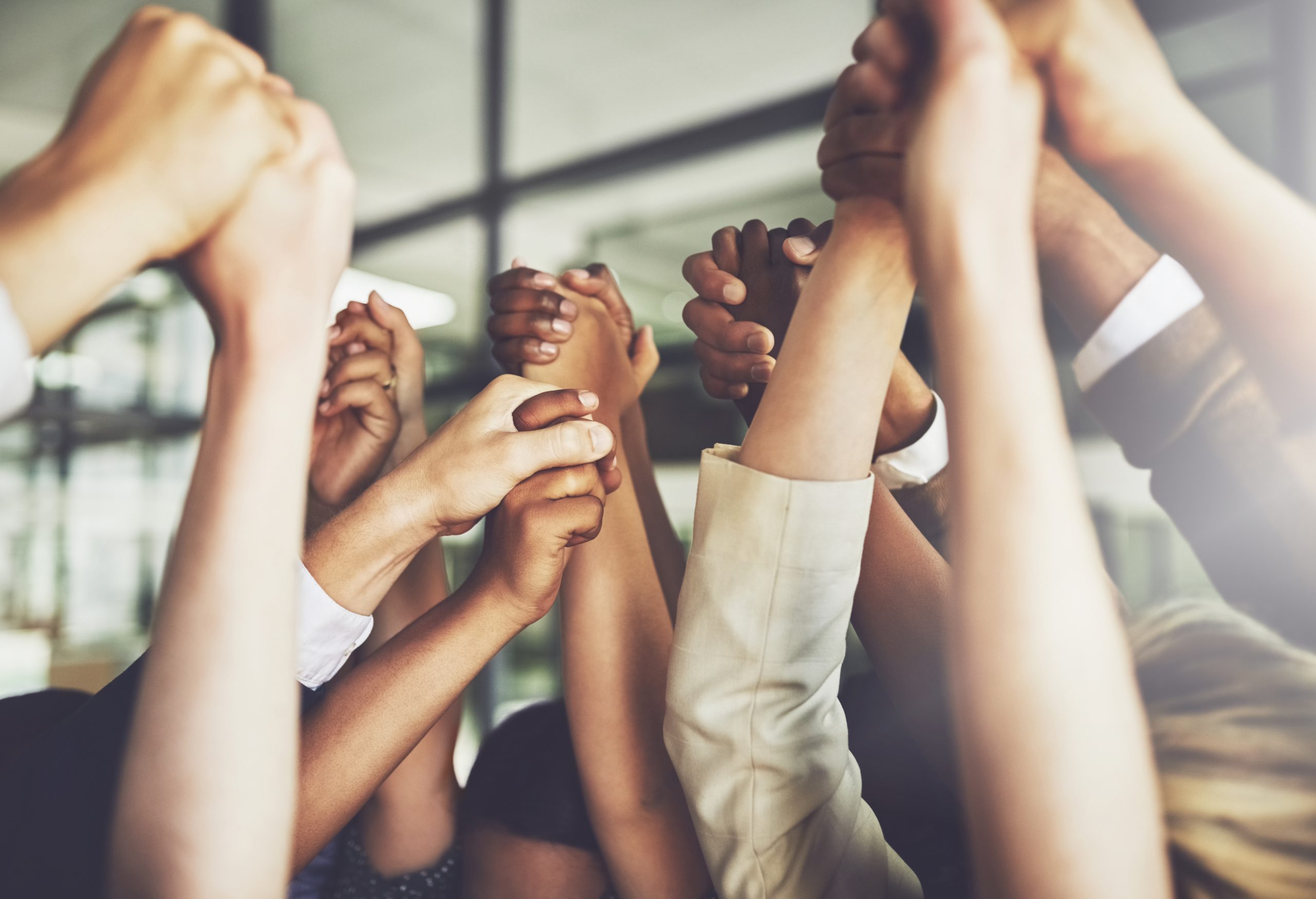 Cropped shot of a group of businesspeople holding hands